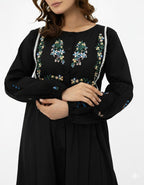 Black dress with floral embroidery on a white background