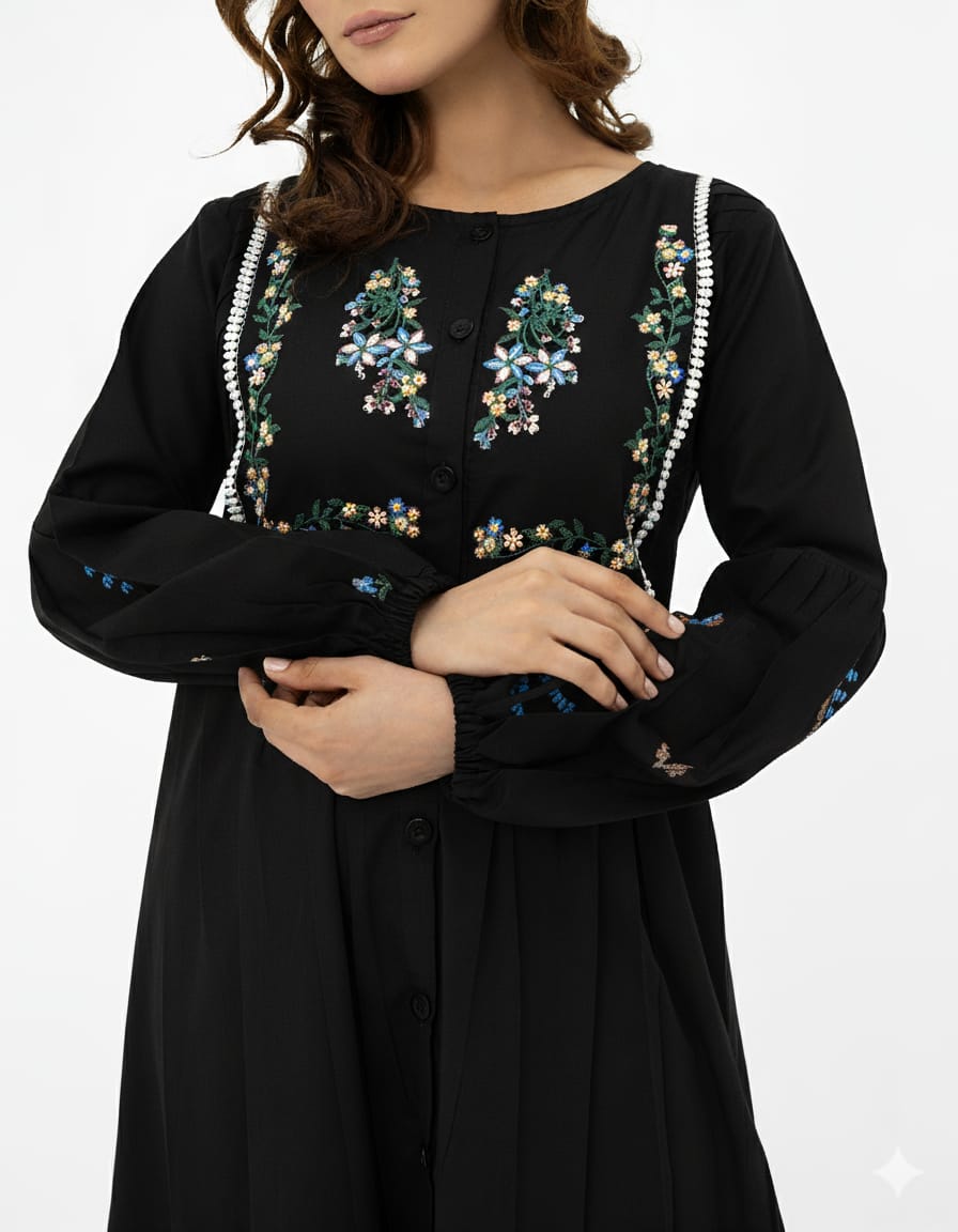 Black dress with floral embroidery on a white background